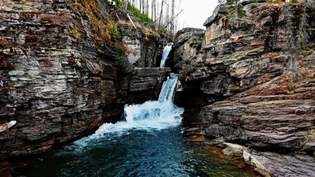 st. mary falls, flanked by reddish granite walls
