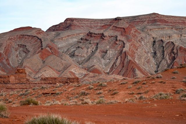 Layers of the mesa backlit – purple, ochre, gray colors of the universe behind mexican hat