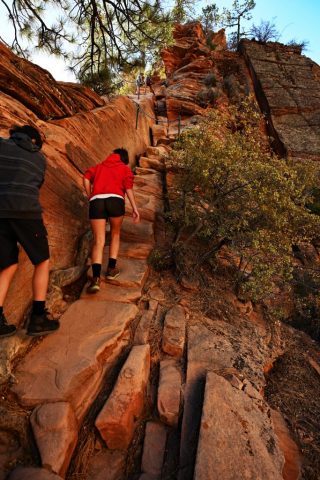 the narrow path zigzagging toward the summit, dotted with colorful hikers. the narrow path zigzagging toward the summit, dotted with colorful hikers.