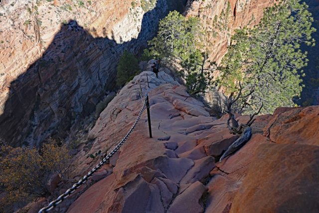 the steep sandstone face illuminated by the sun—shadows tracing every curve. the steep sandstone face illuminated by the sun—shadows tracing every curve.