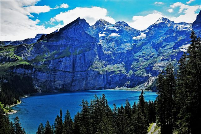 The radiant blue of Lake Oeschinen contrasting with gray and silvery rock faces. dsc 3521