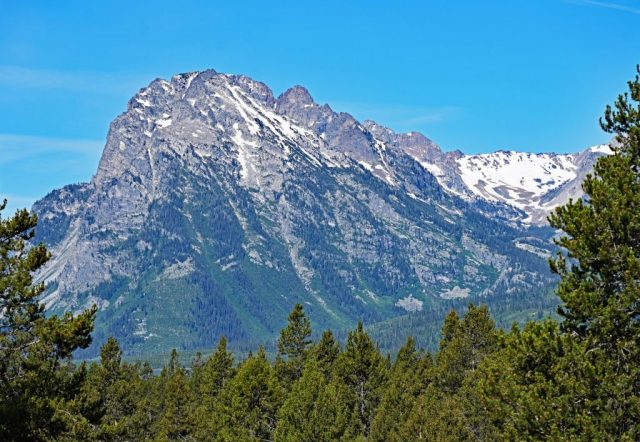 Standing as a stone fortress of granite, the rugged massif of Mount St. John presents itself in the bright summer light. dsc 8179